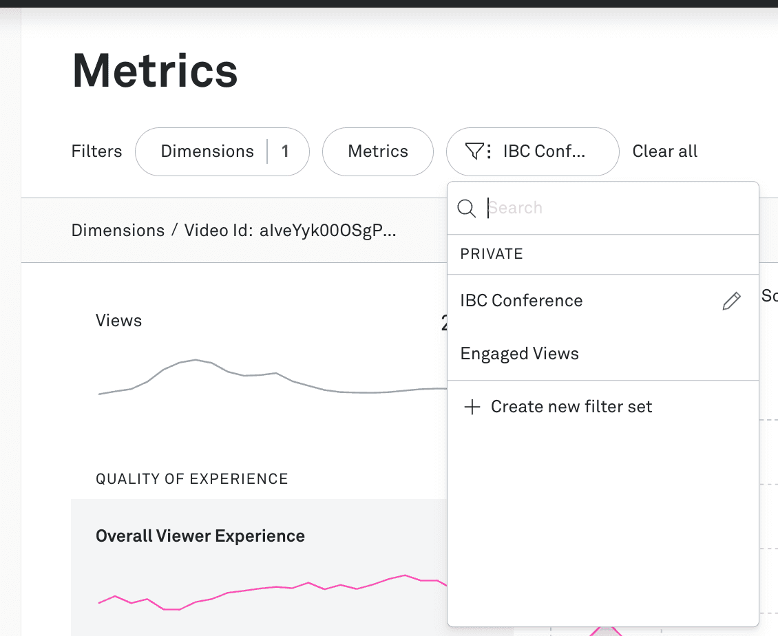 A Mux Metrics dashboard with the filter menu open. The filter dropdown lists private saved filter sets titled “IBC Conference” and “Engaged Views,” along with an option to create a new filter set. The dashboard displays graphs for views and overall viewer experience.